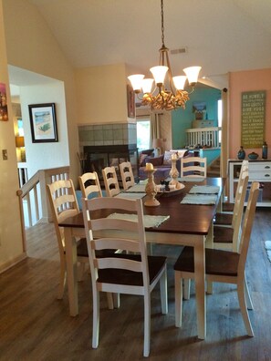 Dining area opens to double sliding doors with deck and screened porch