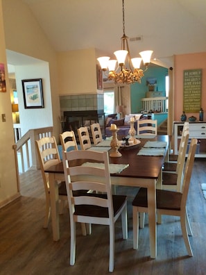 Dining area opens to double sliding doors with deck and screened porch