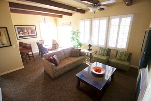 Living room with dining area in the background. 