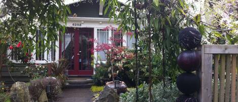 Evergreen clematis and bowling ball 'totems' welcome you to your temporary home.