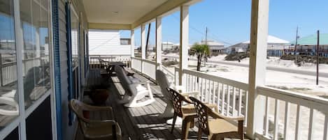 The front porch offers a cool place to relax and look for dolphin swimming by.