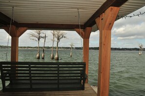 Enjoy the beautiful view of the lake from the swing at the boat house.