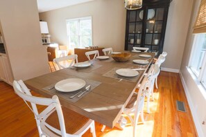 The large dining table comfortably seats 8 people.