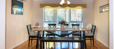 Formal Dining, Air conditioned and over looking leafy back yard with wide window