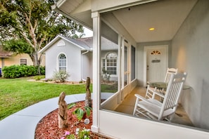 Screened Front Porch with rocking chairs to relax in peace