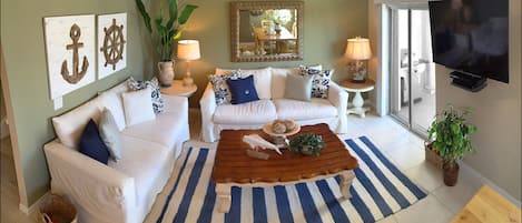 Living Room has South facing Balcony with partial ocean view.