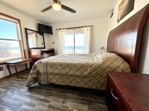 Master bedroom on lower level with an unobstructed ocean and beach view. 