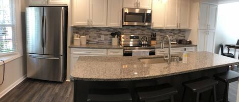 New renovated kitchen with granite countertops, new appliances & tile backsplash