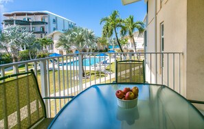 Patio with view over pool and beach beyond