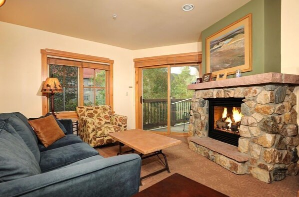 The fireplace provides warmth and coziness to the spacious living area