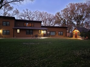 Front of the cabin and bunk house with lights on