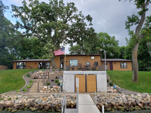 Lake side of cabin with boathouse.