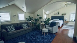 Open arch from sitting area into bedroom area. 