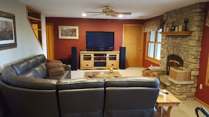 Family Room with leather sectional, big screen, and stereo.