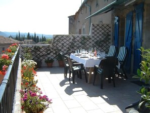 Outside terrace with dining table and sun chairs