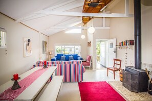 The lounge and dining room featuring a wood burning fireplace