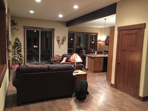 Open living room with 11 ft ceilings.  Leather  sleeper sofa & love seat.