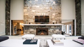 Dramatic Living Room with 20 foot ceilings, Stone Fireplace
