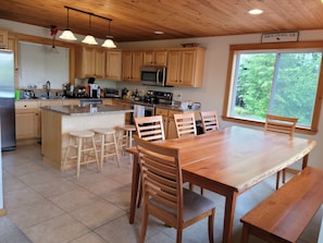 Chefs kitchen with island seating and dining table for 8