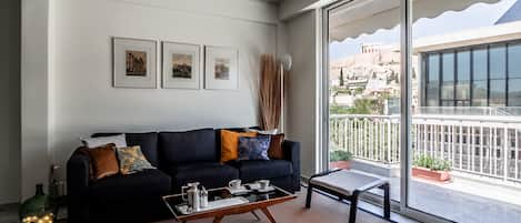 Living-room & balcony. View to the Acropolis Museum and the Parthenon