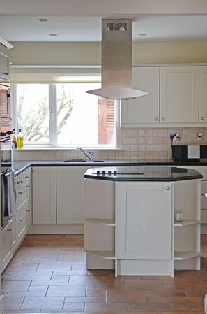 Large kitchen with American appliances. An open plan for entertaining guests.