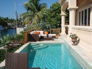 Pool with outdoor furnishings over looking the lagoon.