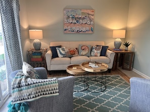 Living room features sofa and 2 swivel chairs for visiting or watching TV