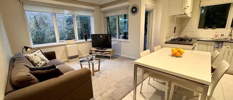 Open plan living/dining room which opens onto balcony