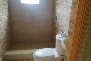 Fully tiled bathroom equipped with hot water.