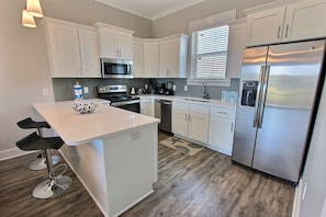 Kitchen with stainless steel appliances and tiled backsplash