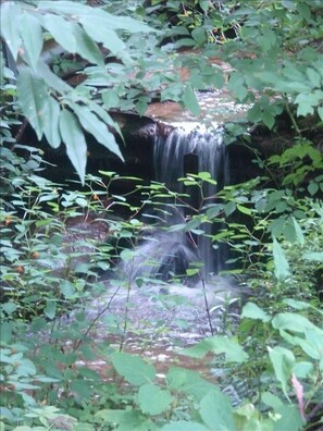 Quaint waterfall on Mitchel's creek lazily streams by our master bedroom