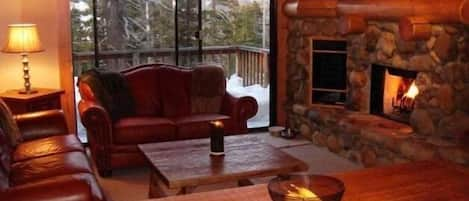 Living room with river rock fireplace and mountain views/Dining table seats 8