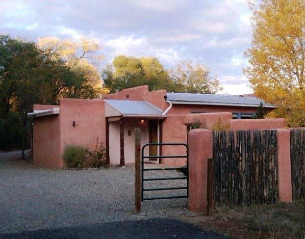 Residence, driveway, and gated parking area.