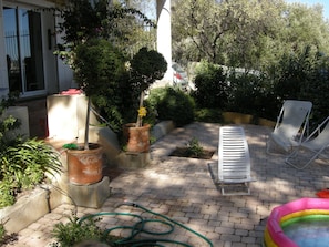 Small garden and its watering hose