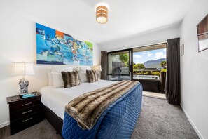 Master Bedroom: Vibrant artwork and stunning mountain views await you in this serene retreat!