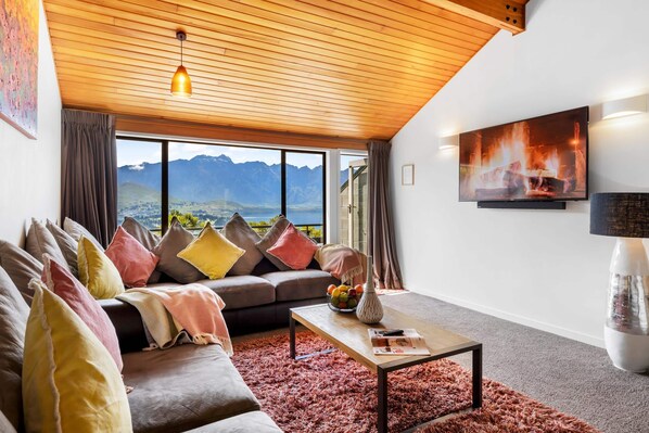 Lounge Retreat: Breathtaking lake and mountain views paired with vibrant decor, comfy and warm furnishings!