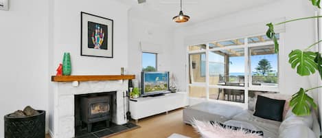 Living area with open fireplace and Smart TV