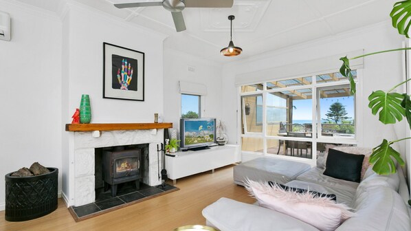 Living area with open fireplace and Smart TV