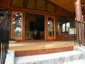 Steps up to the lanai with the French doors open to the living & dining room.