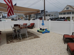 Fence In Yard.  Dining Table  & bar for Adults 
and Children.  4 lounge chairs 