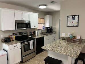 Granite counter tops, 2 stools, kitchen has just about everything you’ll need