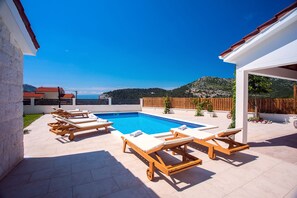 Pool area with 6 sunbeds