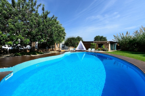 Villa Escoles. Ibiza. Pool surrounded by garden
