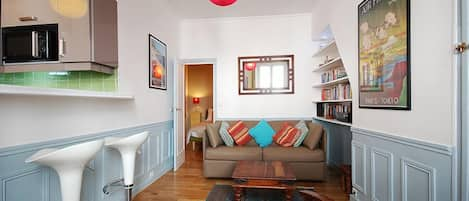 Living room with leather sofa that folds out to a double bed.