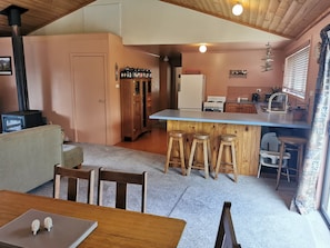 Portocot and high chair under kitchen bench on right.