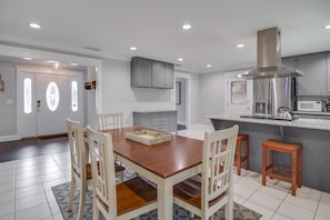 Updated Dining Room & Kitchen w/ stainless fridge, oven, and range hood.