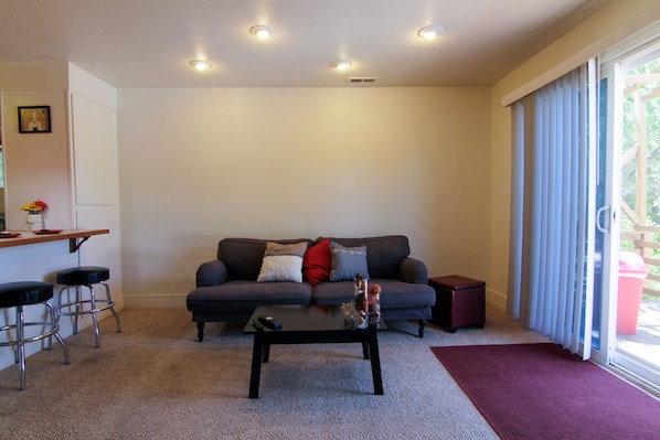 Relax in the comfy living room with a glass of cheer and mounted flatscreen TV.