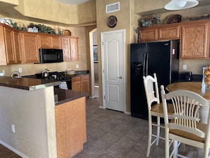 Gourmet kitchen with granite countertops, tile floor, gas stove and more!
