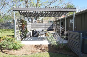 Peaceful, private outdoor patio with vine covered pergola