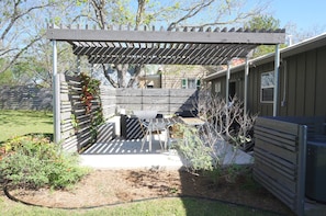 Peaceful, private outdoor patio with vine covered pergola